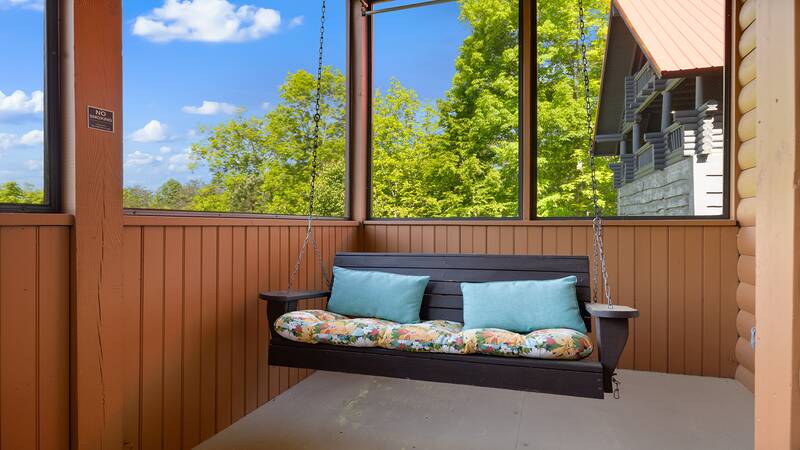 Nice days relax on your cabin's porch swing. at Moonlight Pines Lodge in Gatlinburg TN