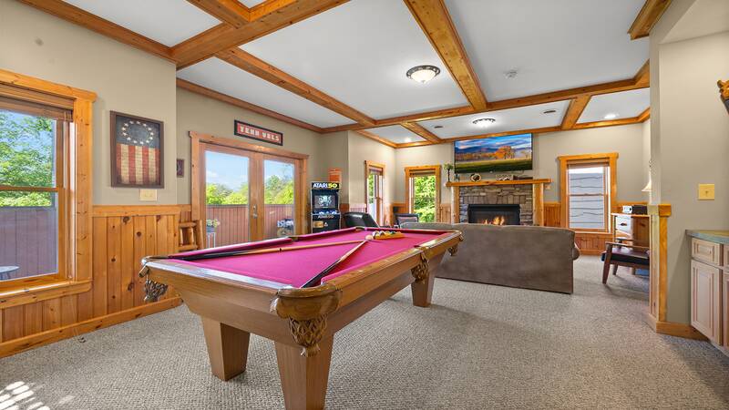 Smokies cabin with pool table, ping pong, multi-game arcade, fireplace and plenty of seating. at Moonlight Pines Lodge in Gatlinburg TN