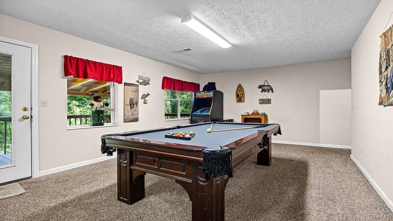 Your Gatlinburg cabin provides the family with a game room pool table and full size multi-game arcade. at Bear Crossing in Gatlinburg TN