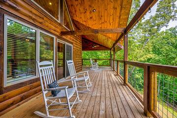 Enjoy your large cabin porch in a wooded setting.  