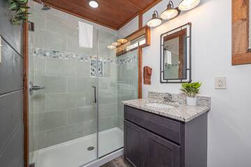 Rental cabin master bath with walk-in shower.
