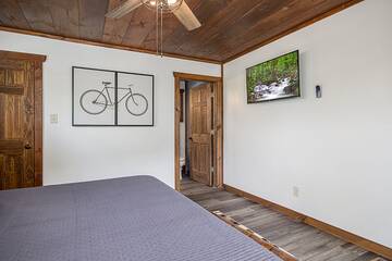 Enjoy late night television in your cabin's master bedroom. 