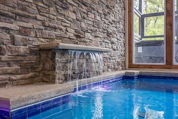 Your in-cabin personal pool with a waterfall. at Mountain Splash Lodge in Gatlinburg TN