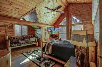 Cabin's loft bedroom with seating area.  at A Great Escape in Gatlinburg TN