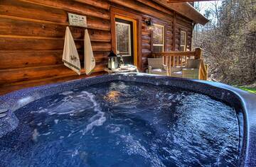 Relax in your cabin's hot tub as the sun sets over the Smokies. at A Great Escape in Gatlinburg TN