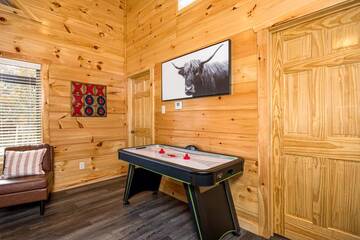 Air hockey table in your cabin rental's game room.