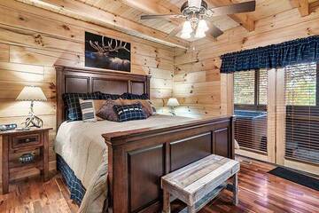 Rental cabin's large bedroom with walk out to the hot tub.  at Alpine Oasis in Gatlinburg TN