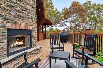 Sit around the outdoors fireplace with friends, family and nature. at Alpine Oasis in Gatlinburg TN