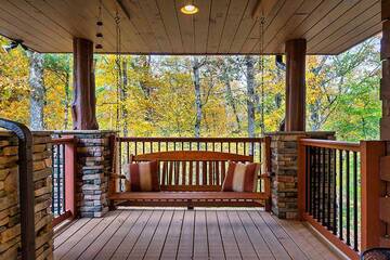 Spend relaxing moments in your log cabin's porch covered swing.