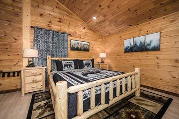 Rest peacefully in this king sized log bed. at Moonlight Obsession in Gatlinburg TN