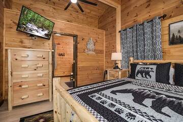 Cabin bedroom with tv and full private bath.