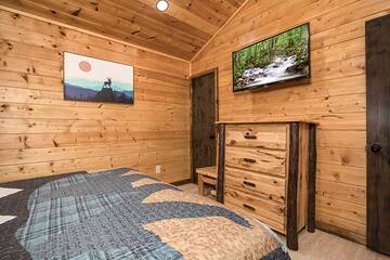 Enjoy late night tv relaxing in your cabin's bedroom.