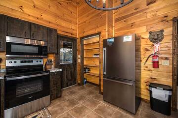 Stainless steel stove and fridge at your cabin in the Smokies.