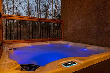 Enjoy the warmth of your cabin's large lighted hot tub.