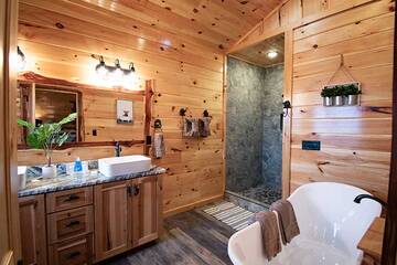 Roomy master bath with clawfoot tub, stone shower and double sink bath. at Morning View in Gatlinburg TN