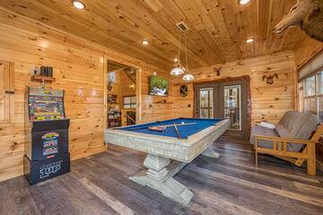 Weather won't dampen your fun at this big cabin's game room.