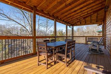 Enjoy eating outdoors on your cabin's porch table.