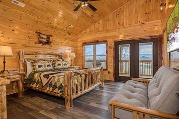 Master bedroom with king sized log bed.