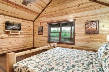 Large 7th bedroom with television. at Cabin Fever Vacation in Gatlinburg TN