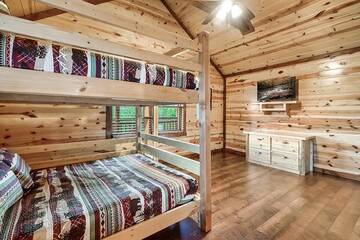 Your cabin's 8th bedroom with bunkbeds and television.