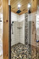Cabin's stone shower with rain faucet.