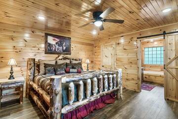 Large king log bed in the cabin's third bedroom.