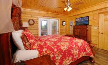Cabin's master bedroom with private bath, Jacuzzi and Fireplace.  at Applewood Manor in Gatlinburg TN