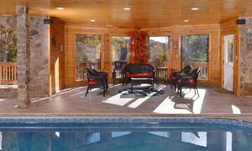 Relax by your cabin rental's indoor swimming pool as other members safely enjoy the water. at Applewood Manor in Gatlinburg TN