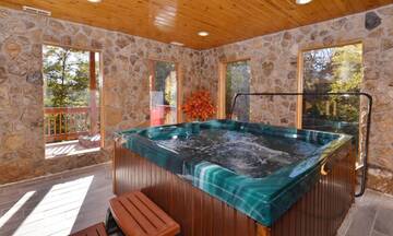 Your 4BR cabin, across from Dollywood, features an all season indoor hot tub. at Applewood Manor in Gatlinburg TN