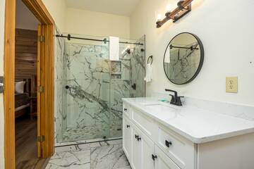 Let it rain warm water in this lovely marbled shower with rain faucet.