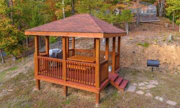 Rental cabin's Gazebo with picnic table, gas grill and charcoal grill. at Applewood Manor in Gatlinburg TN