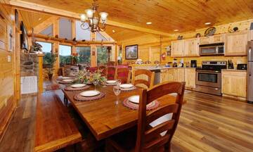 Family meals can be a joy sitting round the cabin's rustic dining table. at Applewood Manor in Gatlinburg TN