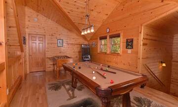 Rental cabin's loft game room with pool table, arcade game, and Foosball table. at Applewood Manor in Gatlinburg TN
