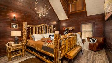Cabin's king sized log bed.