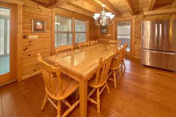 Enjoy holiday meals at your cabin's large dining table. at Wrap Around The Son in Gatlinburg TN