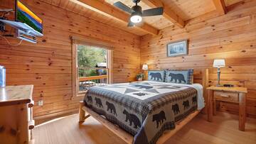 Third bedroom with large comfortable log bed and flat screen tv. at Moonlight Pines Lodge in Gatlinburg TN