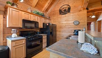 Your Smoky Mountains cabin with a fully equipped kitchen. at Moonlight Pines Lodge in Gatlinburg TN