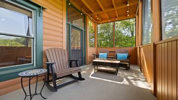 Plenty of seating in the screened in porch for taking in natures sounds. at Moonlight Pines Lodge in Gatlinburg TN