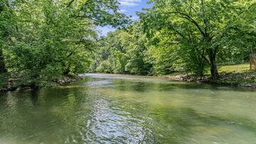 Little Pigeon River as it gently flows past River Bend in Pigeon Forge. at River Waltz in Gatlinburg TN