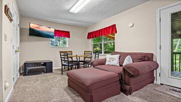 Your cabin's game room offers pleanty of seating and a big screen tv. at Bear Crossing in Gatlinburg TN
