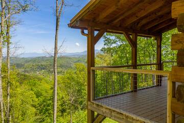 Take in spectacular views of the Smoky Mountains from your cabin's covered porch. at The Appalachian in Gatlinburg TN