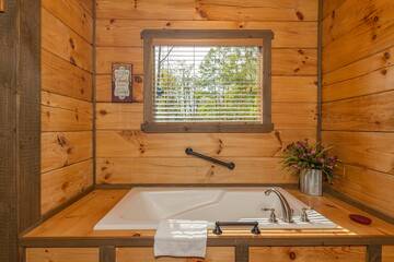 Cabin;s master bedroom Jacuzzi tub for relaxation after a fun filled day in the Smokies.