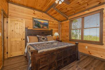 Cabin rental upstairs bedroom with large relaxing bed.