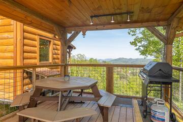 Pigeon Forge area cabin with picnic table and gas grill on the porch. at The Appalachian in Gatlinburg TN