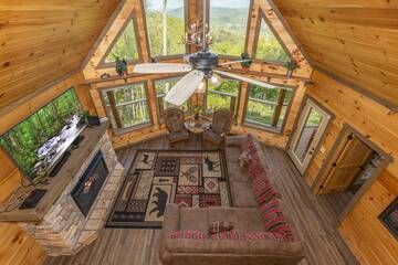 View of the rental cabin's living room from the loft. at The Appalachian in Gatlinburg TN