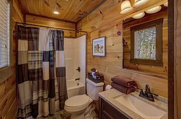 Cabin rental loft bath with tub shower. 