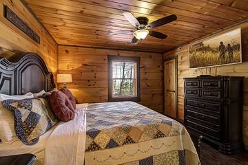 Cabin's second bedroom with flat screen television. 