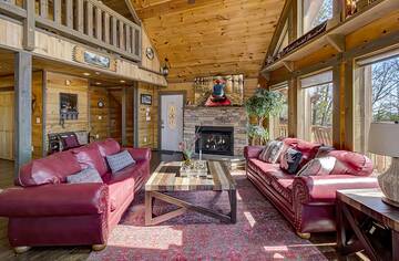 Cabin rental with large living room and fireplace.