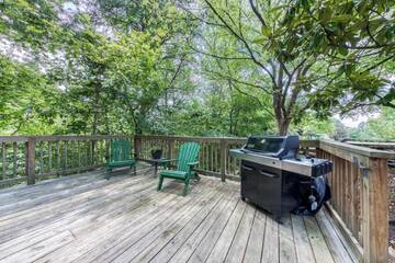 Smokies cabin rental's large deck with seating and gas grill. at Moose Lodge in Gatlinburg TN